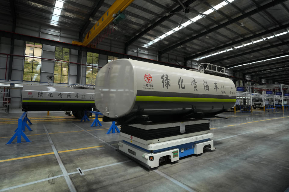 A robot transfers a liquid tank at a Yizhuan Automobile Co. manufacturing factory during a media-organized tour in Shiyan city in central China's Hubei Province on May 12, 2023. China's manufacturing and consumer spending are weakening after a strong start to 2023 after anti-virus controls ended. (AP Photo/Andy Wong)