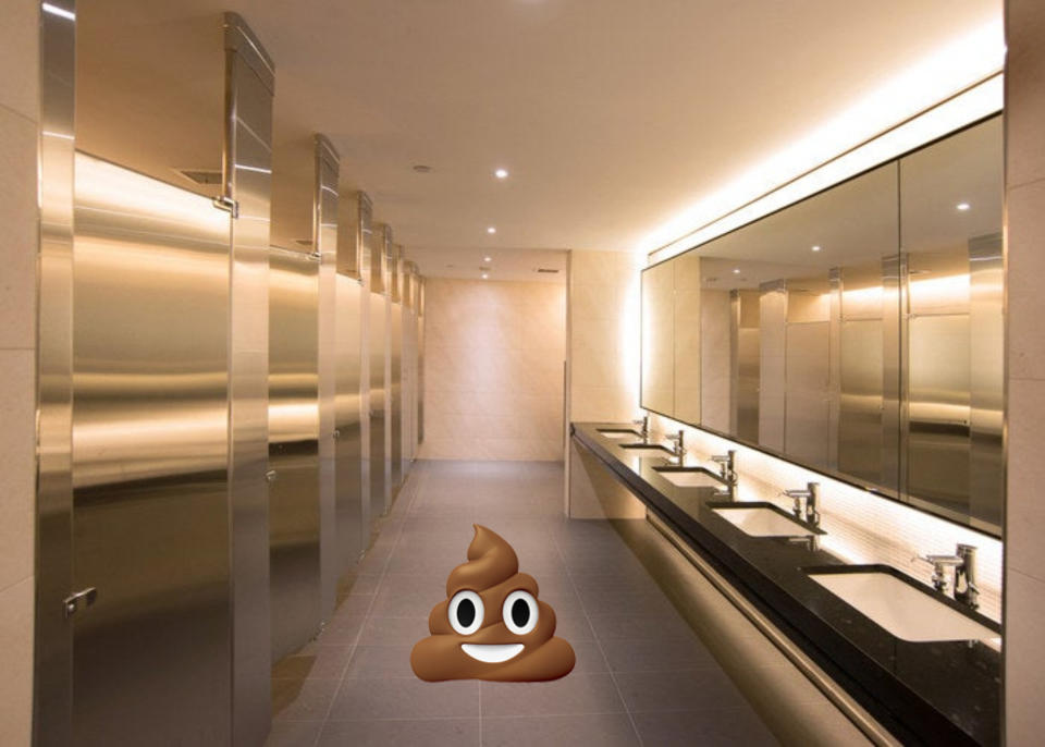 A poop emoji on a bathroom floor