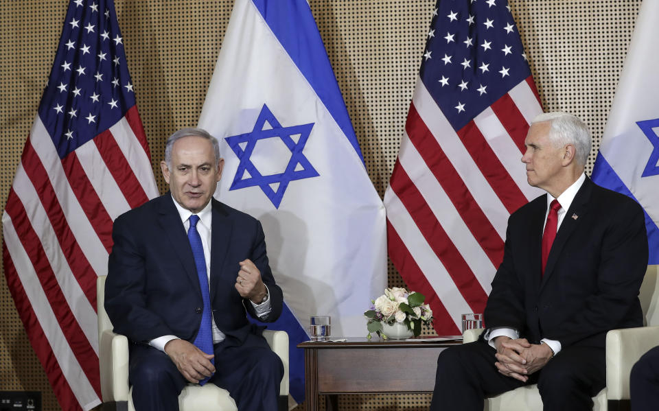 United States Vice President Mike Pence, right, watches Israeli Prime Minister Benjamin Netanyahu, left, making a fist during a bilateral meeting in Warsaw, Poland, Thursday, Feb. 14, 2019. The Polish capital is host for a two-day international conference on the Middle East, co-organized by Poland and the United States. (AP Photo/Michael Sohn)