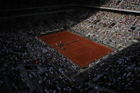 The crowd watch Coco Gauff of the U.S. playing Italy's Martina Trevisan on center court during their semifinal match of the French Open tennis tournament at the Roland Garros stadium Thursday, June 2, 2022 in Paris. (AP Photo/Christophe Ena)