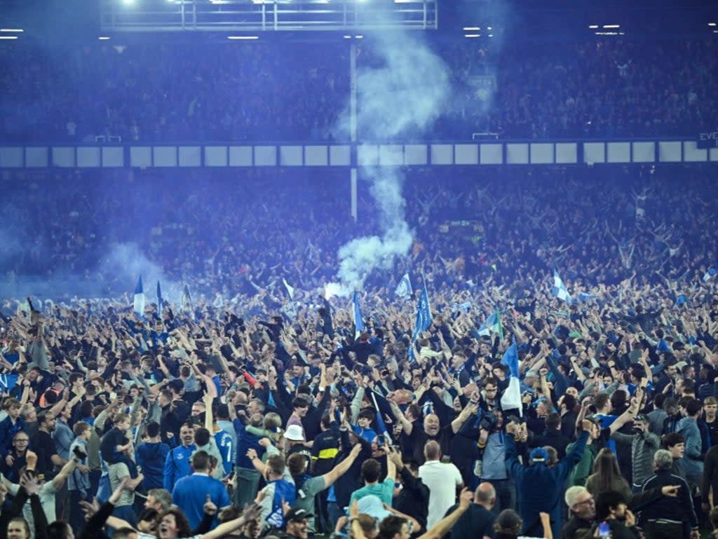 Everton fans celebrate on the pitch at Goodison Park (AFP via Getty Images)