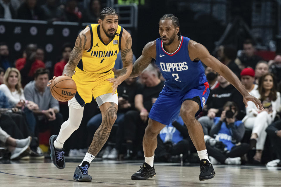 Indiana Pacers forward Obi Toppin (1) dribbles against Los Angeles Clippers forward Kawhi Leonard (2) during the first half of an NBA basketball game Monday, March 25, 2024, in Los Angeles. (AP Photo/William Liang)