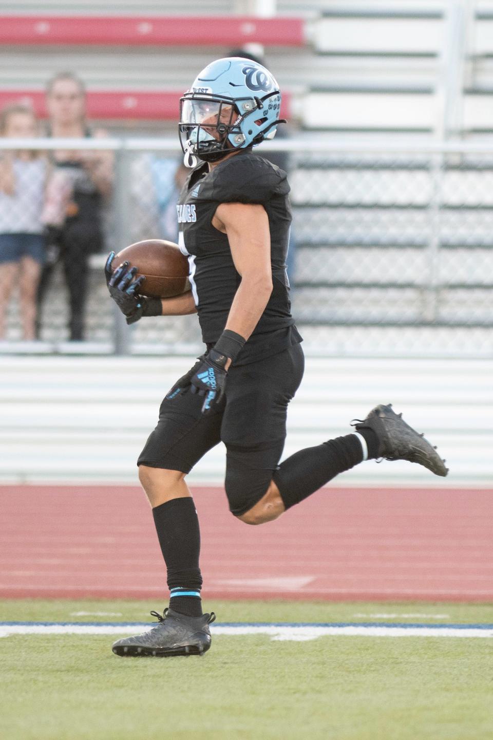 Pueblo West's Garrett O'Brien makes a long run down the sideline during the Pigskin Classic against Pueblo County on Friday, September 1, 2023.