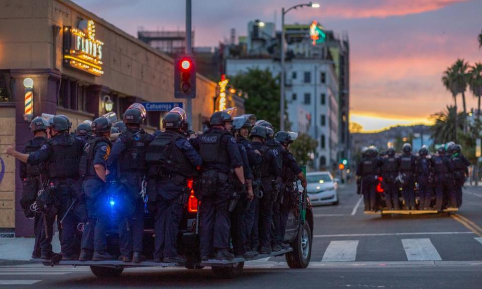 Police move through during demonstrations over the death of George Floyd on 1 June 2020 in the Hollywood section of Los Angeles, California.