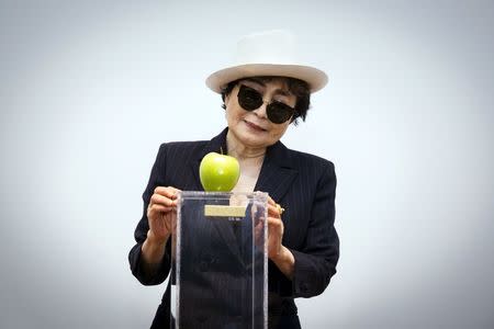 Artist Yoko Ono interacts with the exhibit "Apple" at the Museum of Modern Art exhibition dedicated exclusively to her work, titled "Yoko Ono: One Woman Show, 1960-1971", in New York May 12, 2015. REUTERS/Lucas Jackson