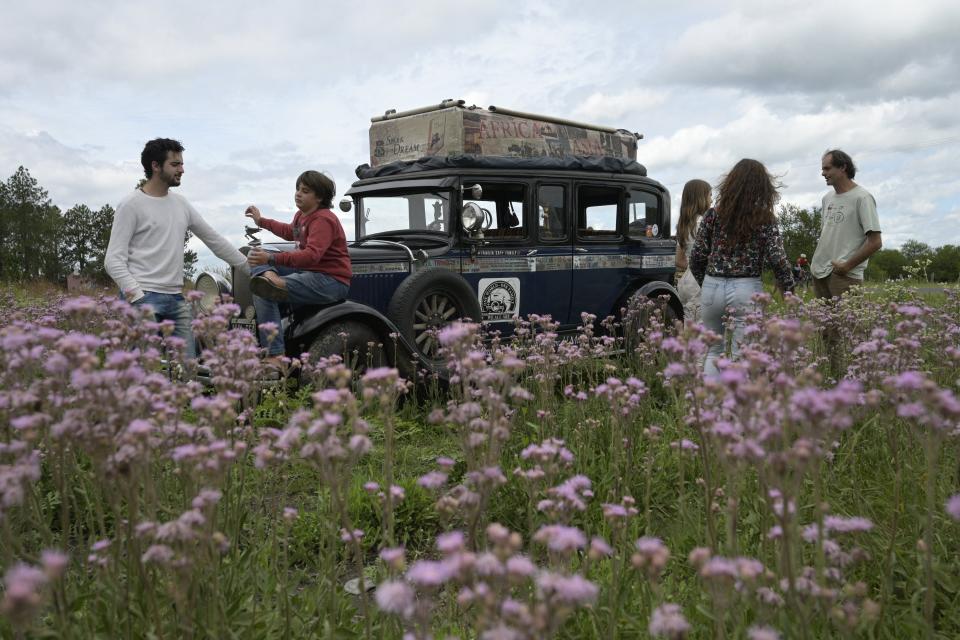 Argentinian Zapp family rests next to its car, a 1928 Graham-Paige, near Gaualeguaychu, Entre Rios province, Argentina, on March 10, 2022. - The family expects to finish on Sunday a 22 year-journey arround the world that started on January 23, 2000 at the Republica square in Buenos Aires. (Photo by JUAN MABROMATA / AFP) (Photo by JUAN MABROMATA/AFP via Getty Images)