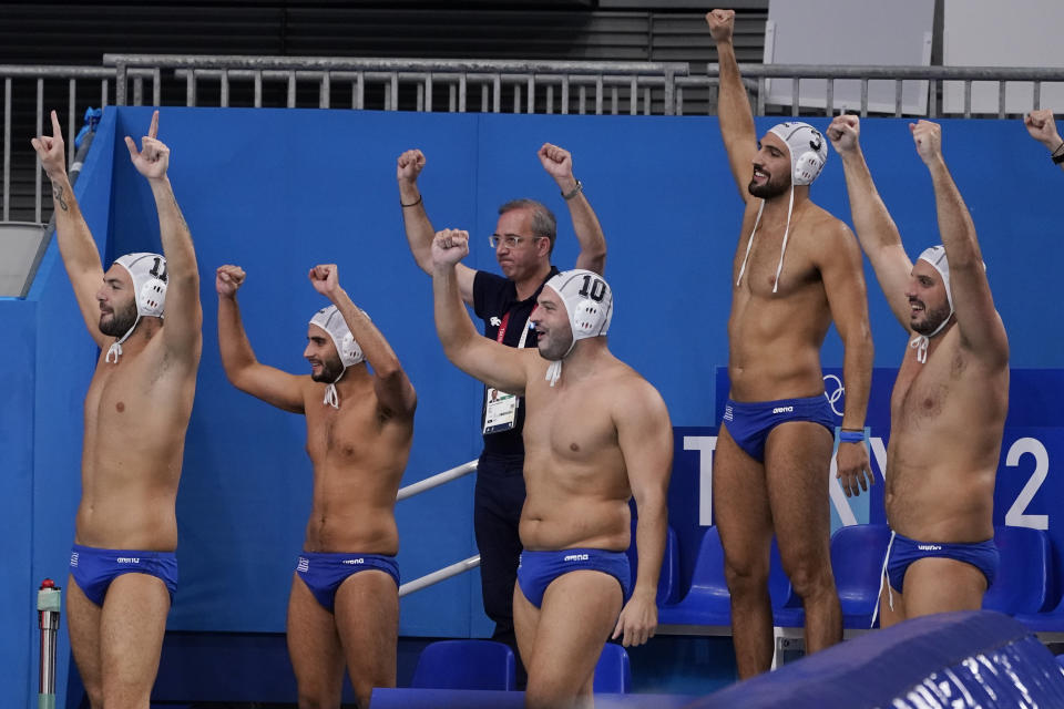 Greece players and coaches celebrate in the final moments of a win over Montenegro in a quarterfinal round men's water polo match at the 2020 Summer Olympics, Wednesday, Aug. 4, 2021, in Tokyo, Japan. (AP Photo/Mark Humphrey)