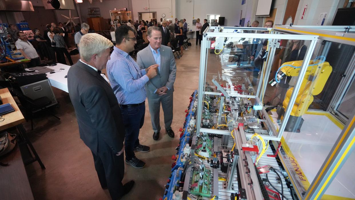 Asif Khan (center) shows Ohio Lt. Gov. Jon Husted (right) a Mechatronics machine Monday afternoon at Central Ohio Technical College's Newark campus. At left is John Berry, the center's president. Husted, Berry and others delivered remarks noting the short-term certificate and degree curriculum for semiconductor worker training in anticipation of the new Intel plant opening in New Albany.