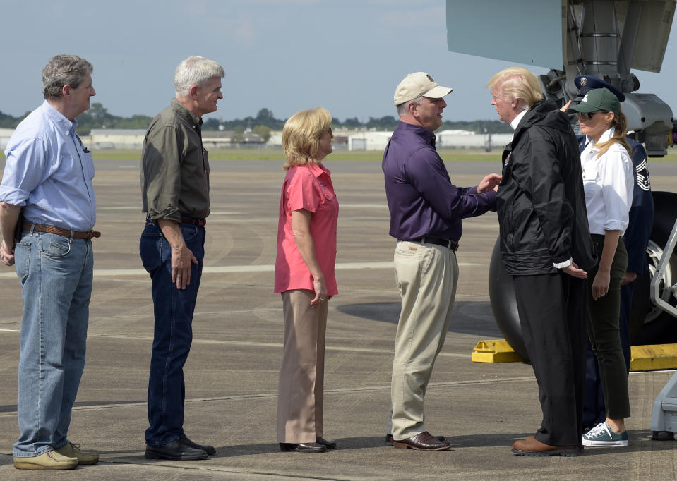 <p>President Donald Trump and first lady Melania Trump meet Louisiana Gov. Governor John Bel Edwards, third from right, and his wife Donna, center, after arriving at Chennault International Airport in Lake Charles, La., to meet people at a county emergency operations center dealing with the impact of Hurricane Harvey, Saturday, Sept. 2, 2017. Other greeting the Trump’s are, from left, Sen. John Kennedy, R-La., and Sen. Bill Cassidy, R-La. (Photo: Susan Walsh/AP) </p>