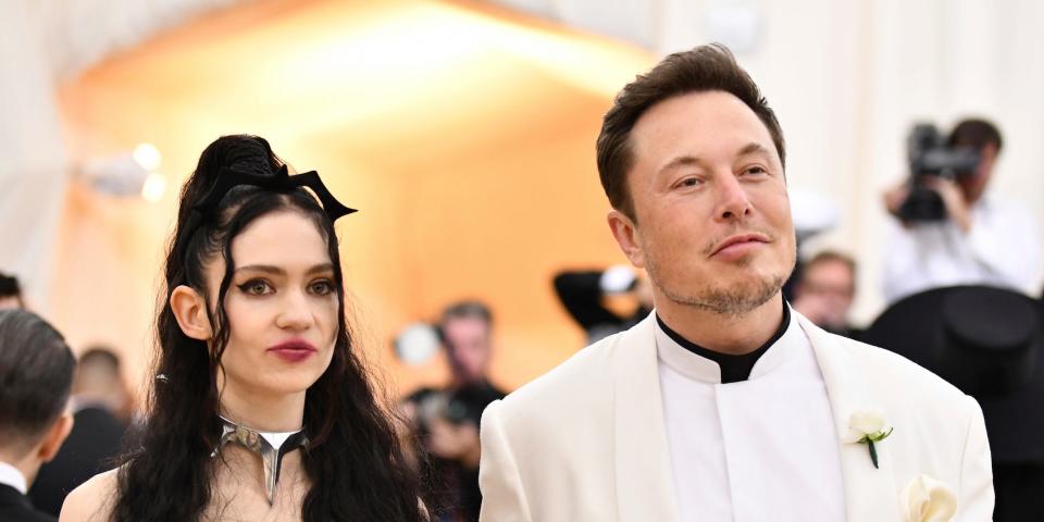 Elon Musk and Grimes stand next to each other in a crowd at Met Gala