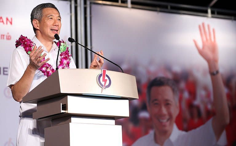 PM Lee's PAP party is returned to power by 60.1 per cent of votes -- the lowest winning margin since independence. (AP photo)