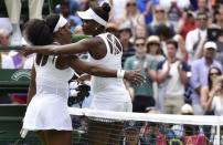 Serena Williams of the U.S.A. embraces Venus Williams of the U.S.A. after winning their match at the Wimbledon Tennis Championships in London, July 6, 2015. REUTERS/Toby Melville