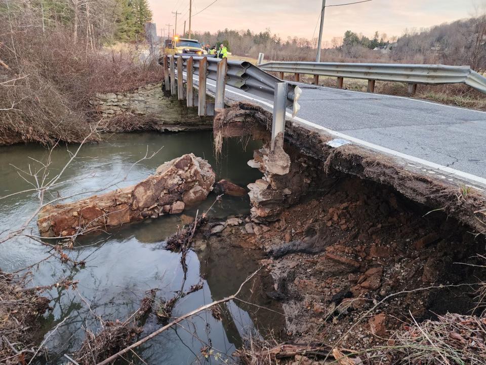 North Carolina Department of Transportation workers inspect the bridge on South Mills Gap Road after it was damaged by the flooding on Jan. 9. The bridge will be closed indefinitely for repairs.