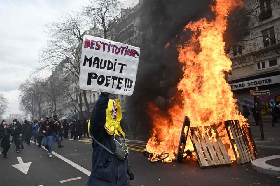 A demonstrator in Paris holds a sign reading “Impeachment!” (AFP/Getty)