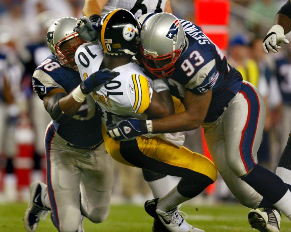 New England's Anthony Pleasant, left, and Richard Seymour, right, knock down Pittsburgh's Kordell Stewart.