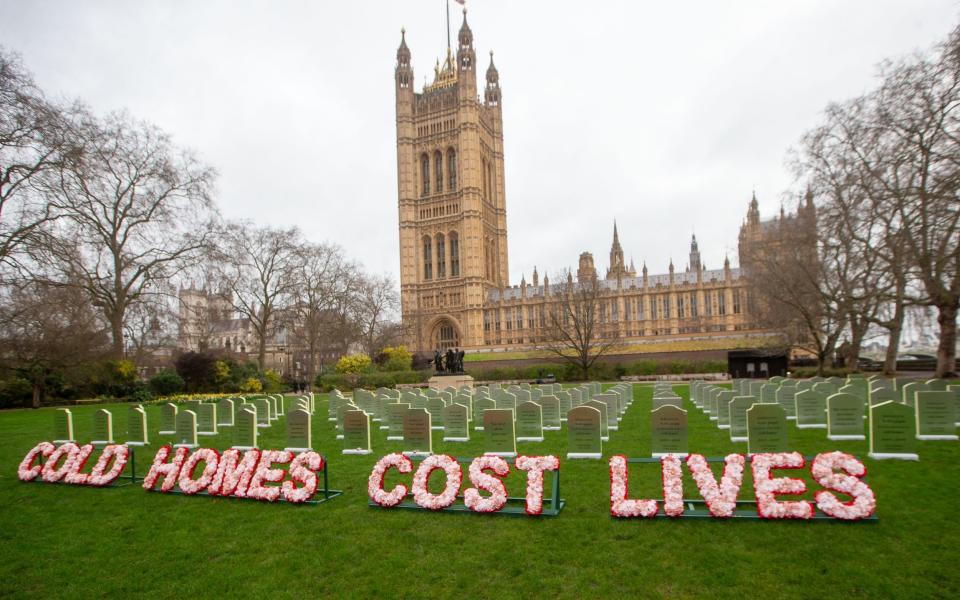 Greenpeace UK activists erected "tombstones" outside Parliament to raise awareness of the impact of cold homes