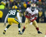 Jan 5, 2014; Green Bay, WI, USA; San Francisco 49ers running back Anthony Dixon (24) rushes with the football as Green Bay Packers cornerback Tramon Williams (38) defends during the third quarter of the 2013 NFC wild card playoff football game at Lambeau Field. Mandatory Credit: Jeff Hanisch-USA TODAY Sports