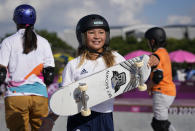 Sky Brown of Britain, center, walks away after chatting with Sakura Yosozumi of Japan, left, and Misugu Okamoto of Japan, right, as they take part in a women's park skateboarding practice session at the 2020 Summer Olympics, Monday, Aug. 2, 2021, in Tokyo, Japan. (AP Photo/Ben Curtis)