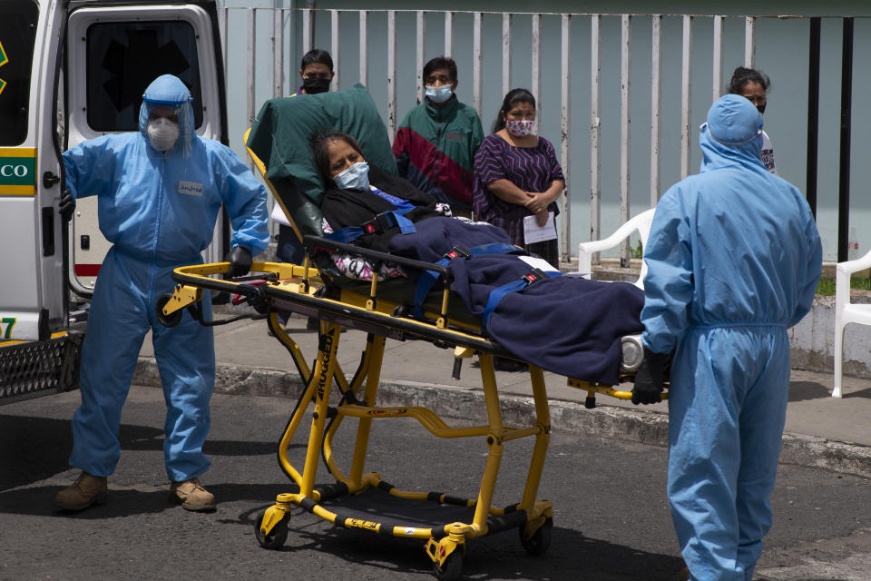 A patient with symptoms related to COVID-19 is brought to the coronavirus unit at the San Juan de Dios Hospital in Guatemala City, Tuesday, June 16, 2020. (AP Photo/Moises Castillo)