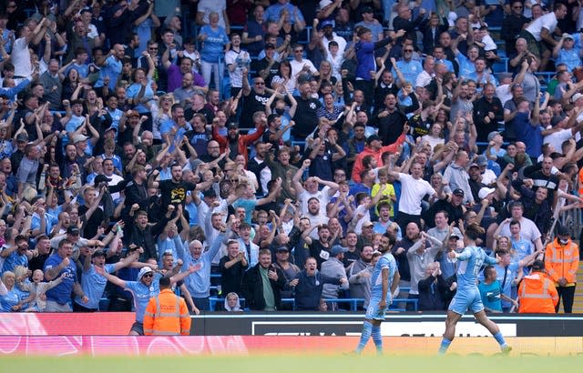 Manchester City's Ilkay Gundogan celebrates his opening goal in a 5-0 win over Arsenal in front of the home fans as Jack Grealish joins him