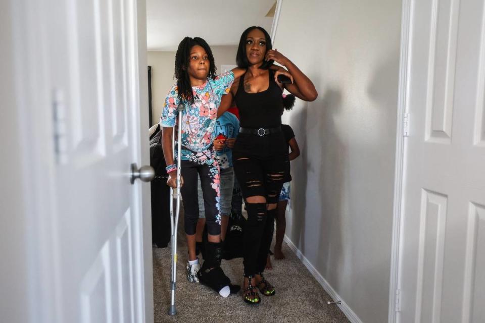 Aalayah Fulmore, left, and her mother Stacy, at a welcome-home party for Aalayah last September. Today, her leg still isn’t fully healed. And her family still wants the perpetrator brought to justice.