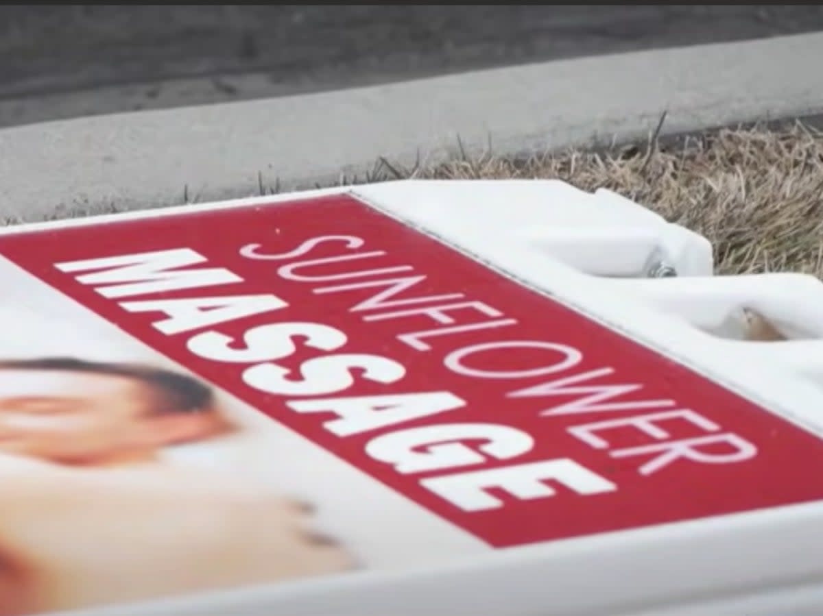 A sign for Sunflower Massage in American Fork, Utah, lying on the ground after police raided the business on suspicion that illegal sex services were being offered by workers (screengrab/KSL5)