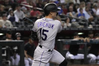 Colorado Rockies' Randal Grichuk hits an RBI single against the Arizona Diamondbacks during the seventh inning during a baseball game Saturday, Aug. 6, 2022, in Phoenix. (AP Photo/Rick Scuteri)