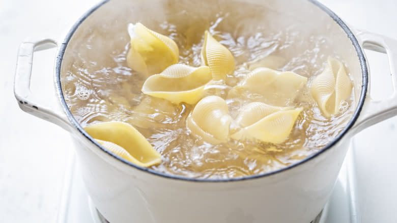 large pasta shells in boiling water