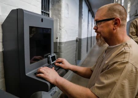 Inmate Steven Goff connects his JPay tablet device to a kiosk inside the East Jersey State Prison in Rahway, New Jersey, U.S., July 12, 2018. REUTERS/Brendan McDermid