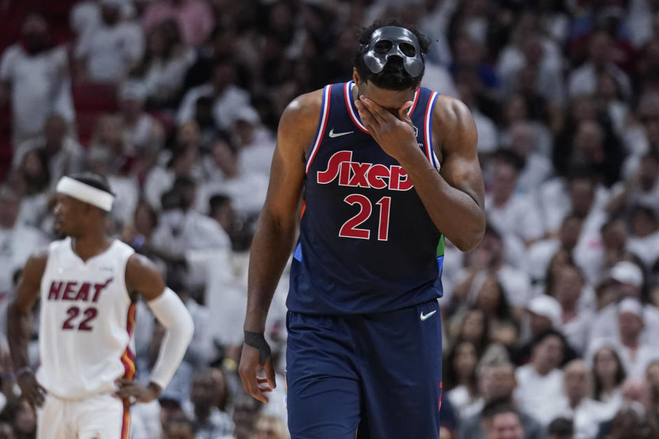 Philadelphia 76ers center Joel Embiid (21) wipes his face during the second half of Game 5 of an NBA basketball second-round playoff series against the Miami Heat, Tuesday, May 10, 2022, in Miami. (AP Photo/Wilfredo Lee)