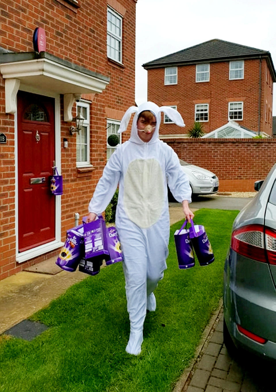 Sebbie Hall dressed as an Easter bunny to hand out 365 chocolate eggs which were donated to him for his challenge. (Supplied Ashley Hall/SWNS)