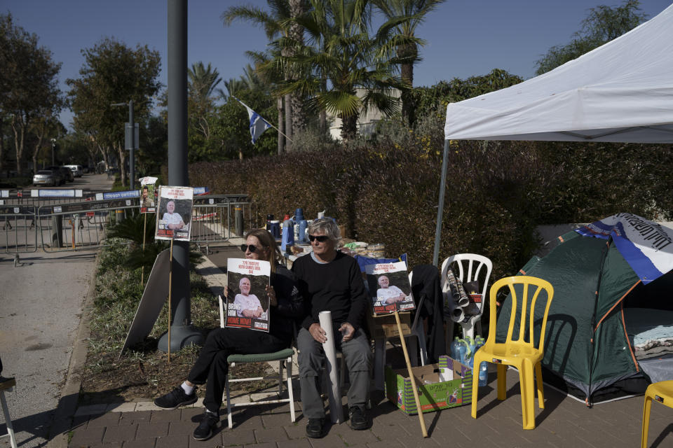 Relatives and friends of hostages sit on a camp set up outside the private residence of the Israeli Prime Minister Benjamin Netanyahu, in Caesarea, Israel, Saturday, Jan. 20, 2024, in support of a father of an Israel hostage held in Gaza who has begun a hunger strike to protest the government's lack of visible progress on a new hostage deal. (AP Photo/Leo Correa)