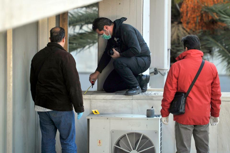 Police investigators seach for evidence at the Athens' National Gallery on January 9, 2012.