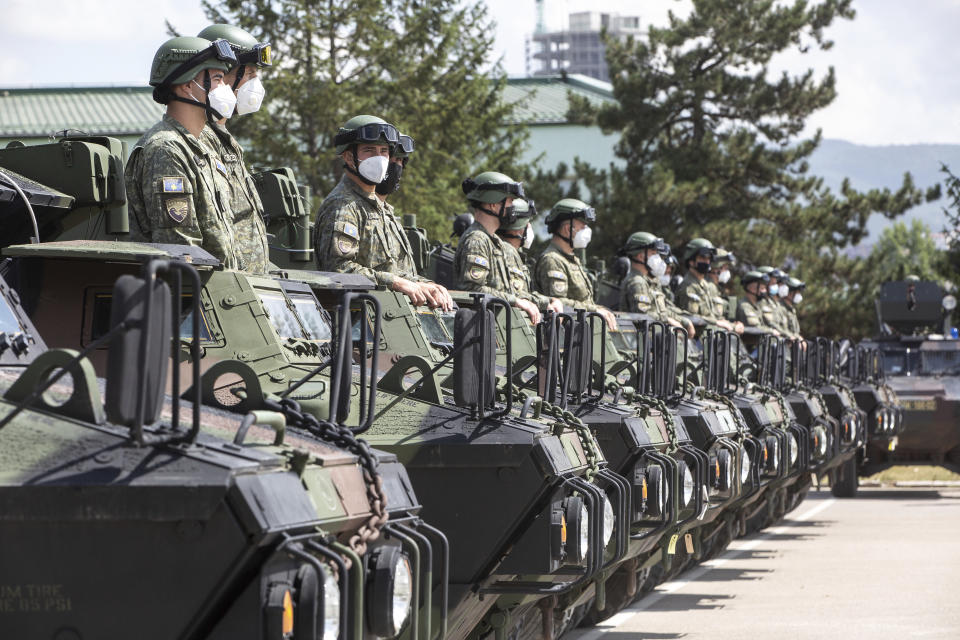 Kosovo Security Force soldiers sit on top of armored Security vehicles donated by U.S during a handout ceremony in the military barracks Adem Jashari in capital Pristina on Monday, Aug. 30, 2021. U.S as the main suppliers of Kosovo's defense the U.S donated 55 armored security vehicles to Kosovo Army. (AP Photo/Visar Kryeziu)