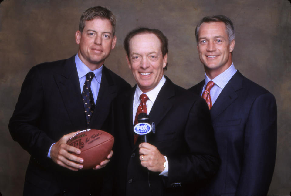 In this 2001 photo provided by Fox Sports, Troy Aikman, Dick Stockton and Daryl Johnston, from left, pose for a photo, location not known. Stockton has done his final game on network television after a 55-year career that included stints with Fox, CBS and NBC. He has cut back on work in recent years, doing only NFL games for Fox and said during a telephone interview Friday, March 26, 2020, that he had been contemplating retirement for the past year. (Jason Wilheim/Fox Sports via AP)