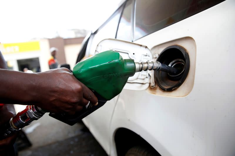 FILE PHOTO: An employee pumps fuel into a car at a Shell petrol station in Nairobi
