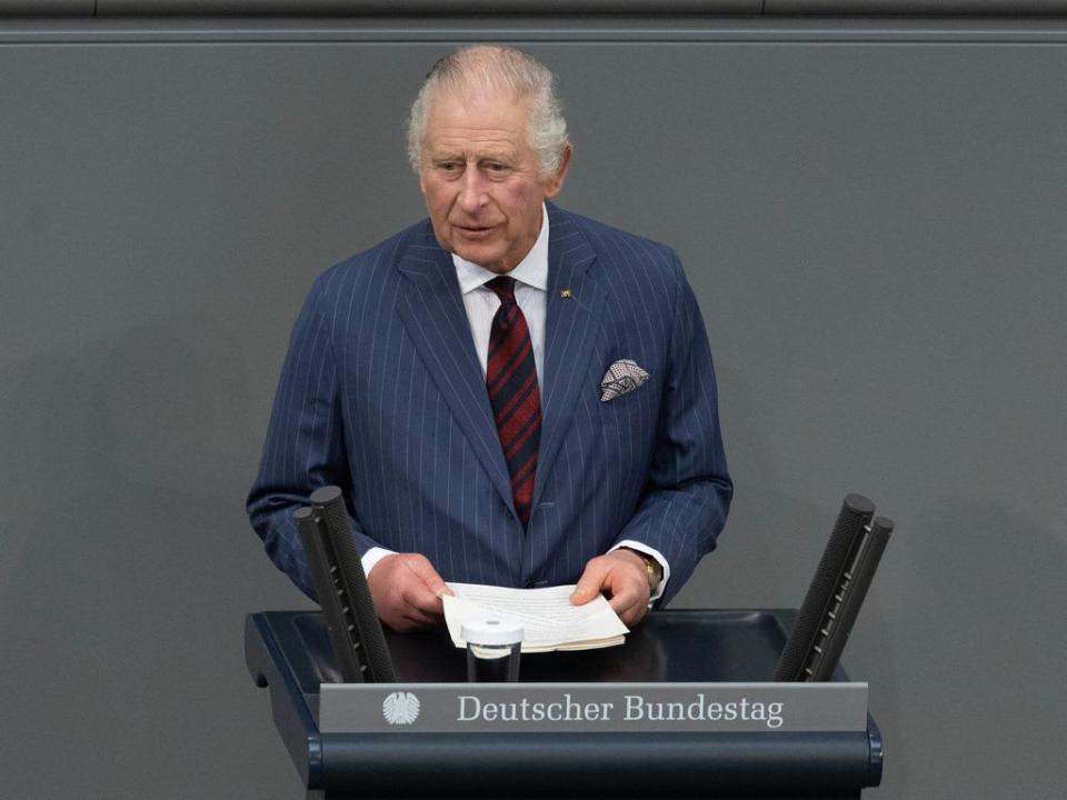 King Charles delivering a speech in a blue suit