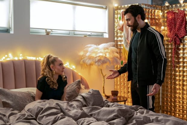 Roy (Brett Goldstein) catching Keeley having an intimate moment with herself and a video of his retirement speech (with the De La Vali dress behind his head).<p>Photo: Courtesy of Apple TV+</p>