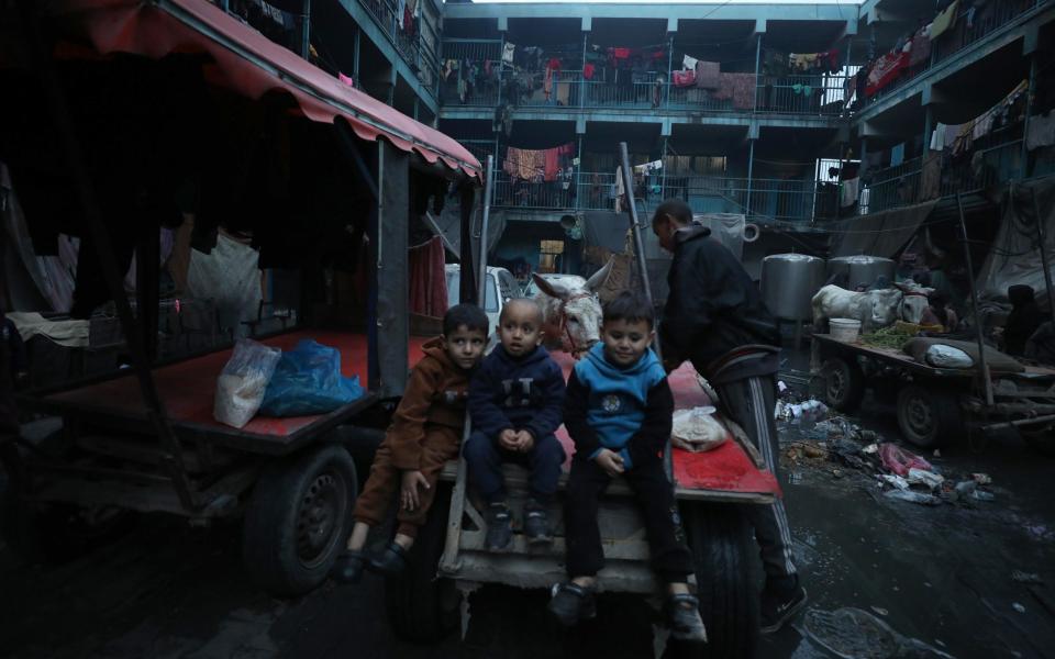 Palestinians try to live under harsh conditions with limited facilities at a shelter center while the Israeli attacks continue in Gaza City