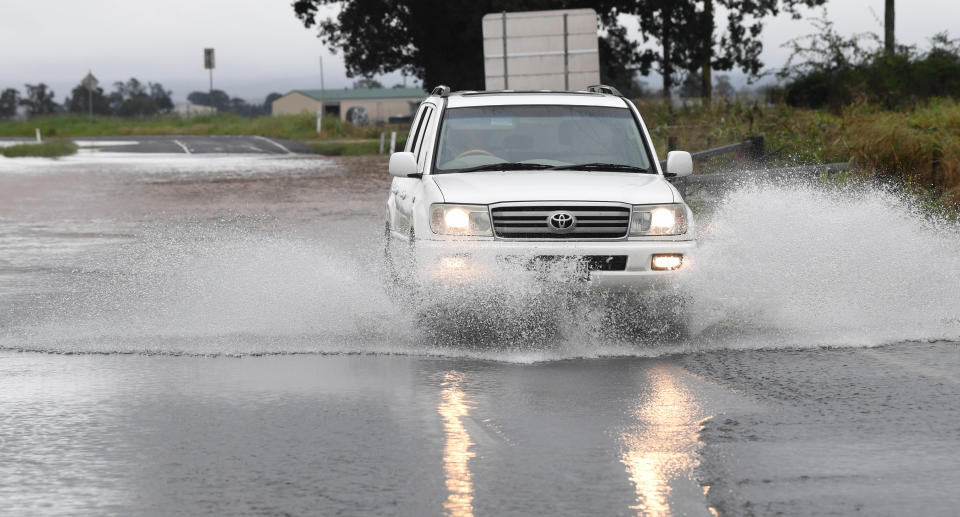 A car driving through a flooded road