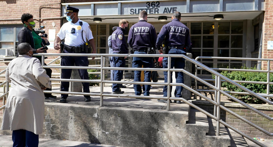 Police at a building where a dad allegedly killed his partner and her two daughters. 