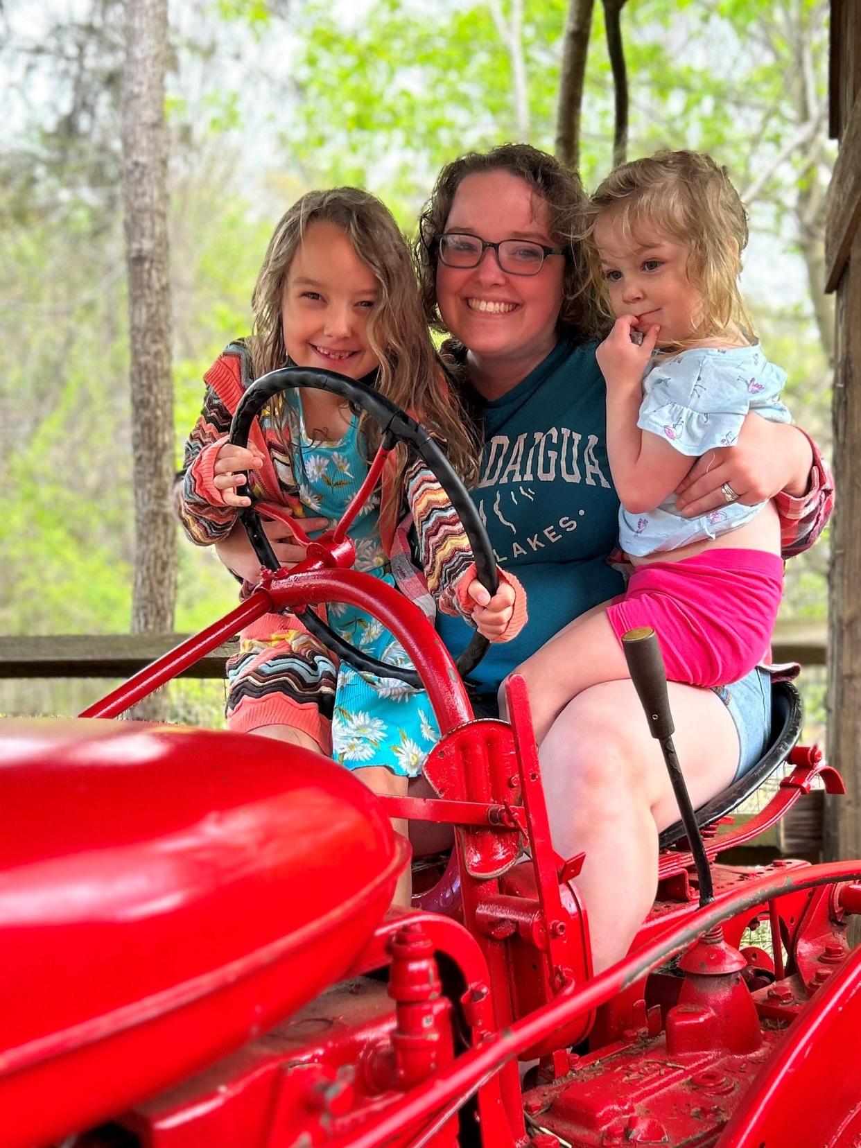 Asheville opinion writer Chelsea Boes with her children, Bravery, far left, and Jubilee.