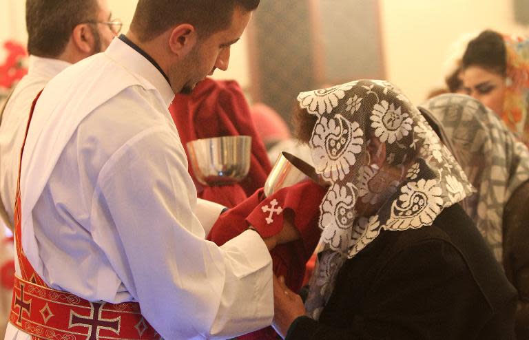 Assyrian Christians attend a Christmas mass in Beirut on December 25, 2014. There were around 30,000 Assyrians in Syria before the country's conflict erupted in March 2011 but many have fled the violence