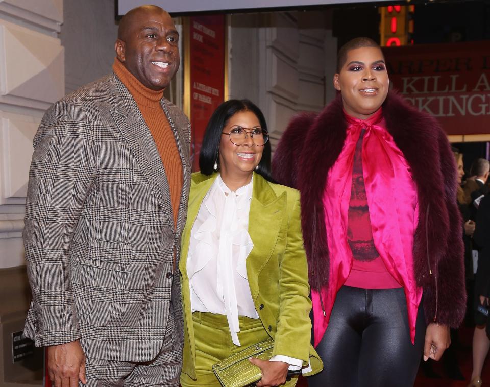 Magic Johnson, Cookie Johnson, and E.J. Johnson pose together while smiling.