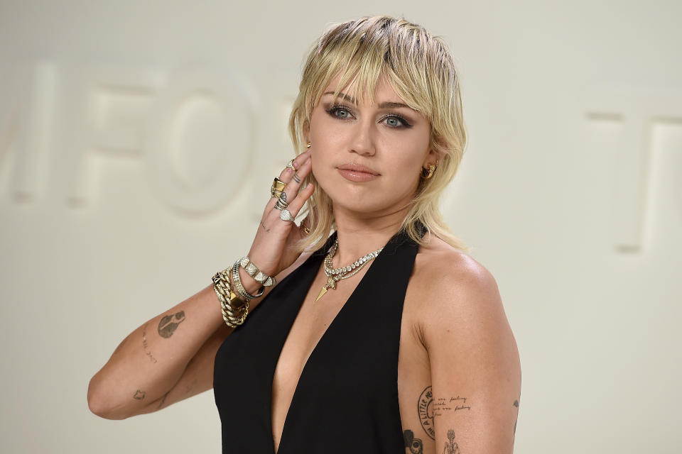 FILE - Miley Cyrus attends the Tom Ford fashion show in Los Angeles on Feb. 7, 2020. Cyrus’ “Endless Summer Vacation” is up for album of the year and best pop vocal album. The single “Flowers” is nominated for Grammy three awards. (Photo by Jordan Strauss/Invision/AP, File)