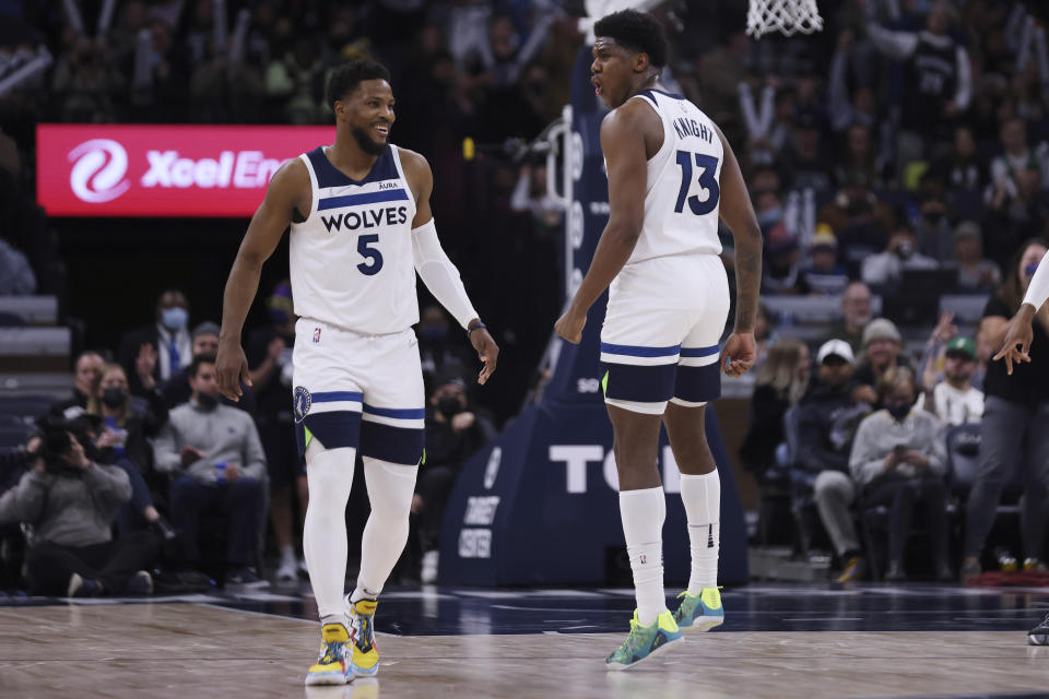 Minnesota Timberwolves forward Nathan Knight (13) celebrates with guard Malik Beasley (5) after hitting a 3-pointer during the second half of the team's NBA basketball game against the Boston Celtics, Monday, Dec. 27, 2021, in Minneapolis. Minnesota won 108-103. (AP Photo/Stacy Bengs)
