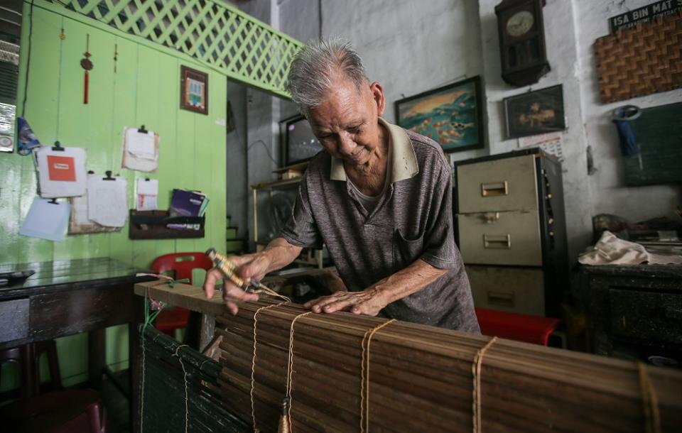 Chick blinds weaver Lau Chee Wah said he works from morning to night when an order comes in.