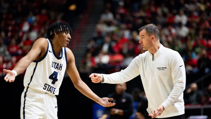 Utah State Aggies head coach Danny Sprinkle talks to Utah State Aggies guard Ian Martinez (4) during the game between the Utah State Aggies and the San Diego State Aztecs in the semifinals of the Mountain West 2024 Men's Basketball Championship at the Thomas & Mack Center in Las Vegas on Friday, March 15, 2024.