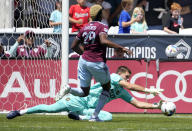 Los Angeles FC goalkeeper John McCarthy, bottom, makes a save as Colorado Rapids attacker Gyasi Zardes closes in during the first half of an MLS soccer match Saturday, May 14, 2022, in Commerce City, Colo. (AP Photo/David Zalubowski)