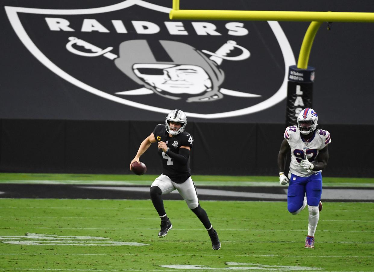 <p>Quarterback Derek Carr #4 of the Las Vegas Raiders is chased by defensive end Mario Addison #97 of the Buffalo Bills during the second half of the NFL game at Allegiant Stadium on October 4, 2020 in Las Vegas, Nevada. </p> ((Photo by Ethan Miller/Getty Images))